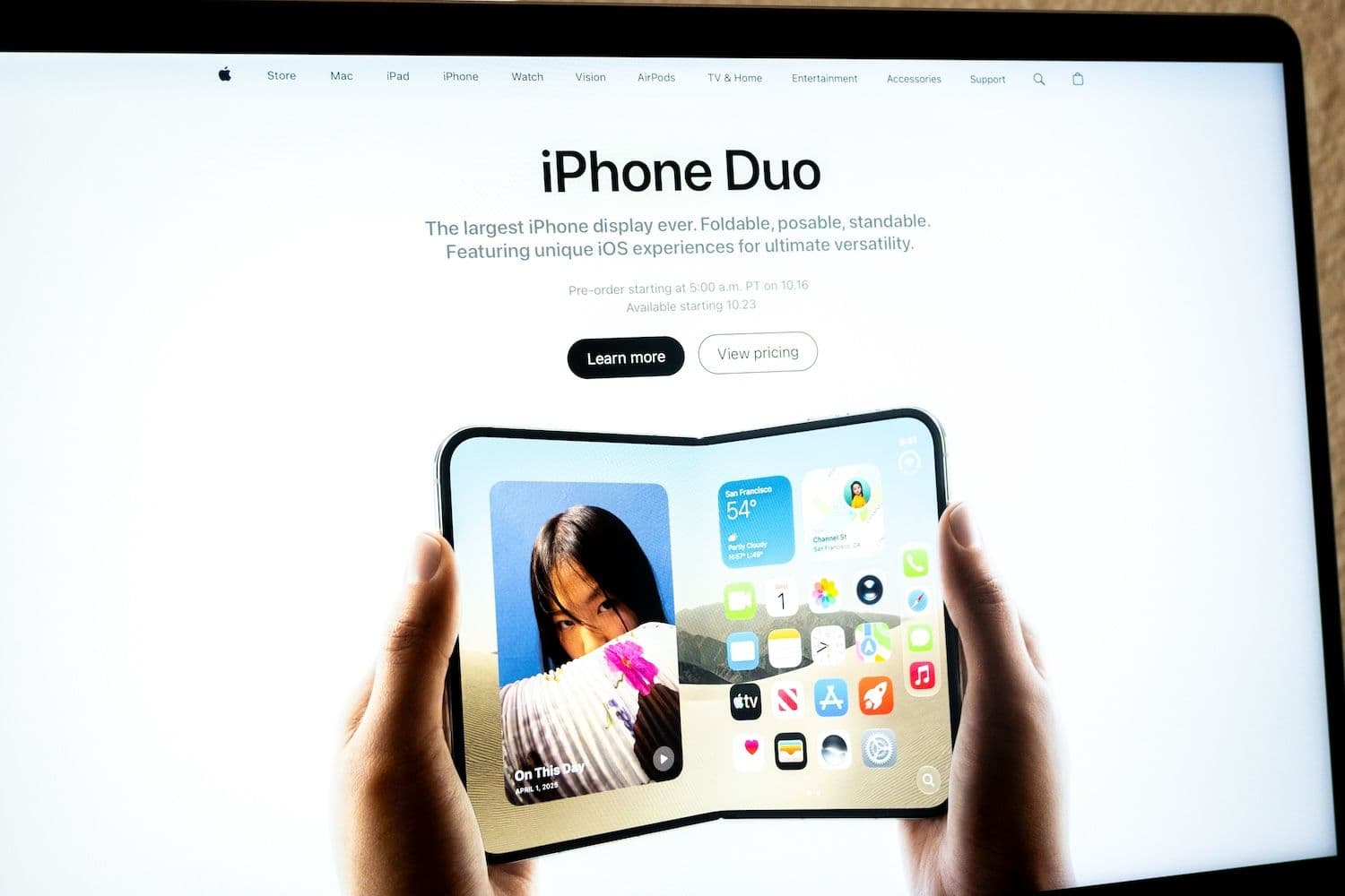 Documents appear as a book-style spread on Apple's $1,999 iPhone Duo in a newly surfaced clip ahead of Oct. 16 preorders (Image: Shutterstock)